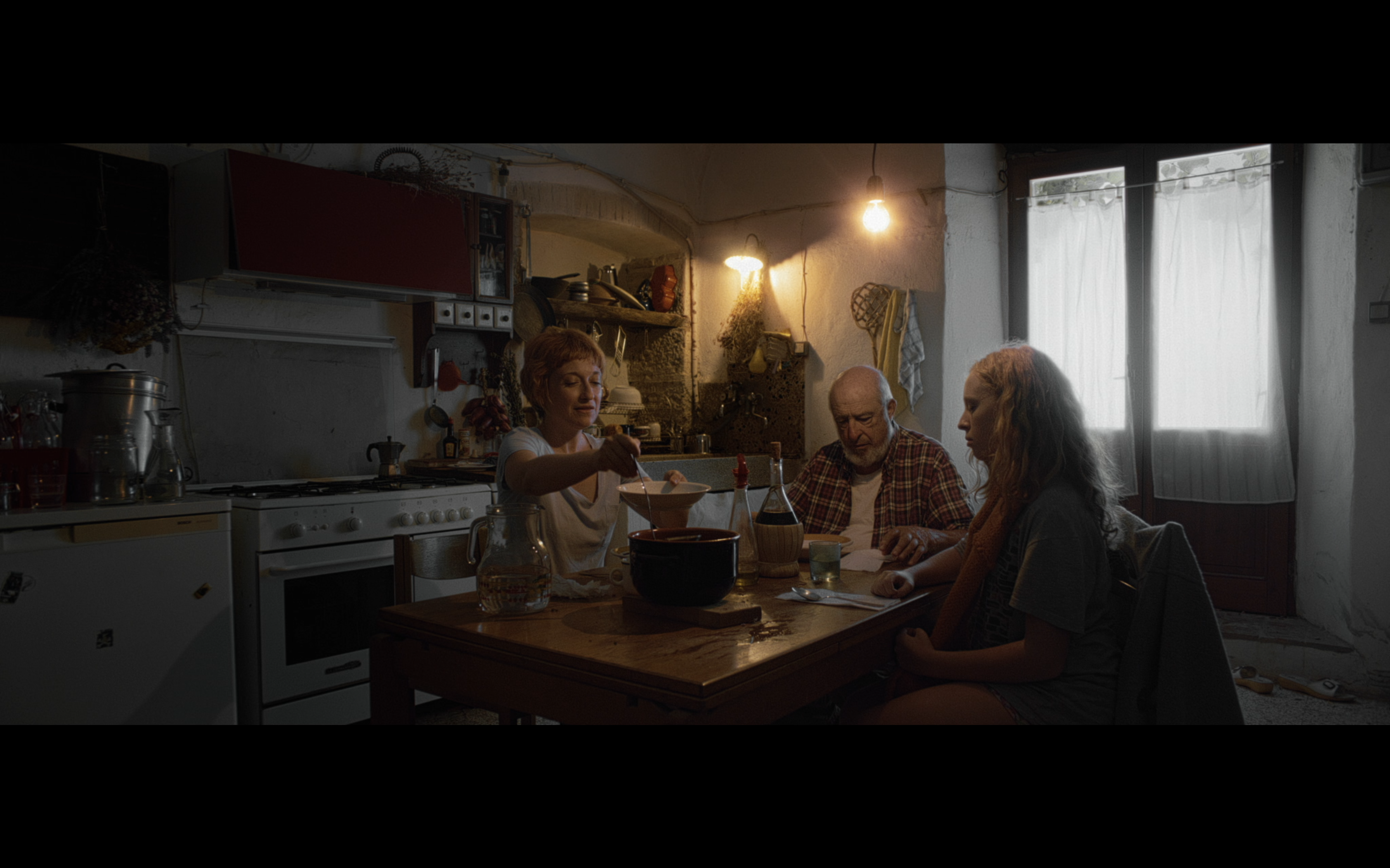 A family at a kitchen table in warm daylight