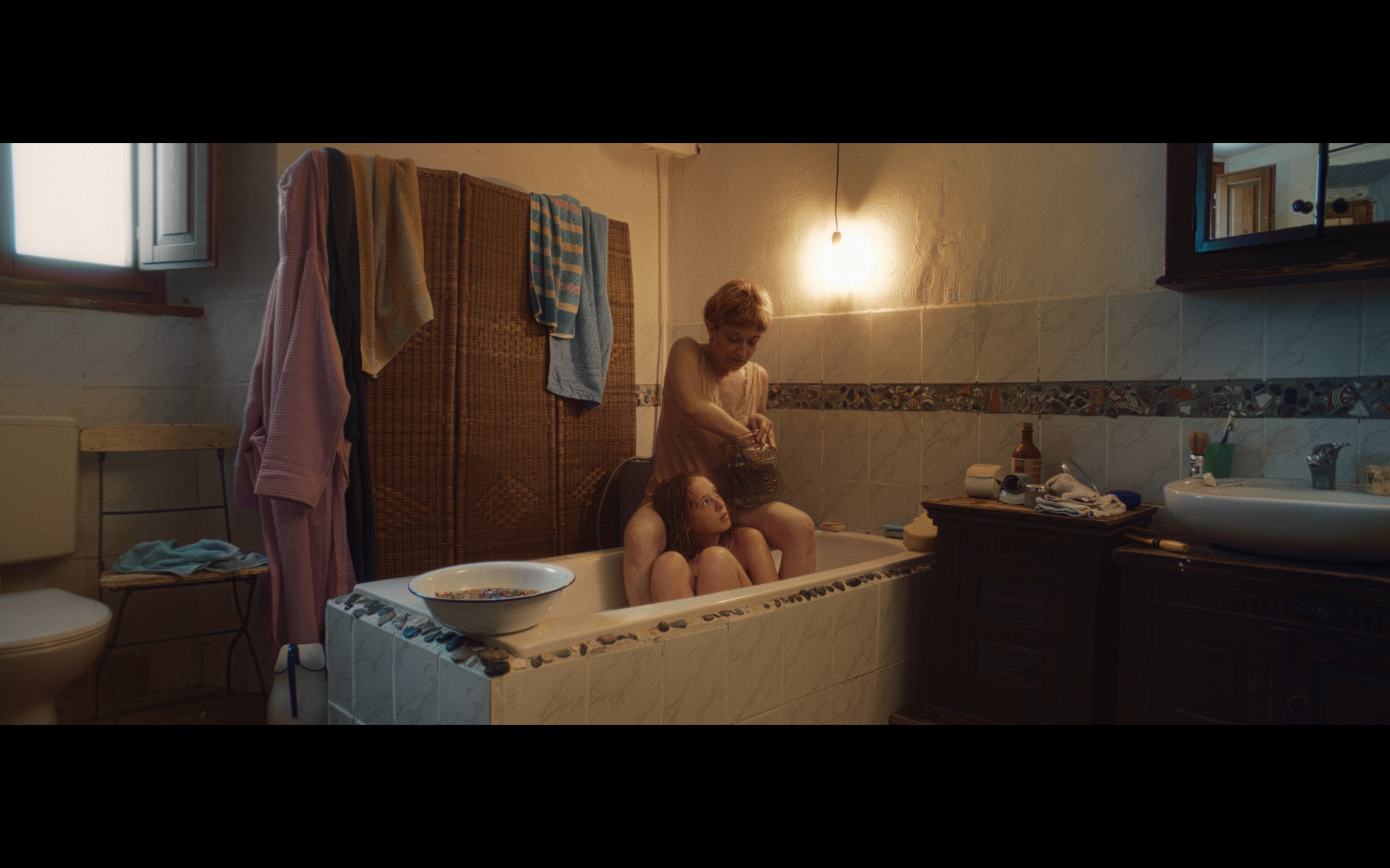 A woman and a girl beside a flower-filled bath