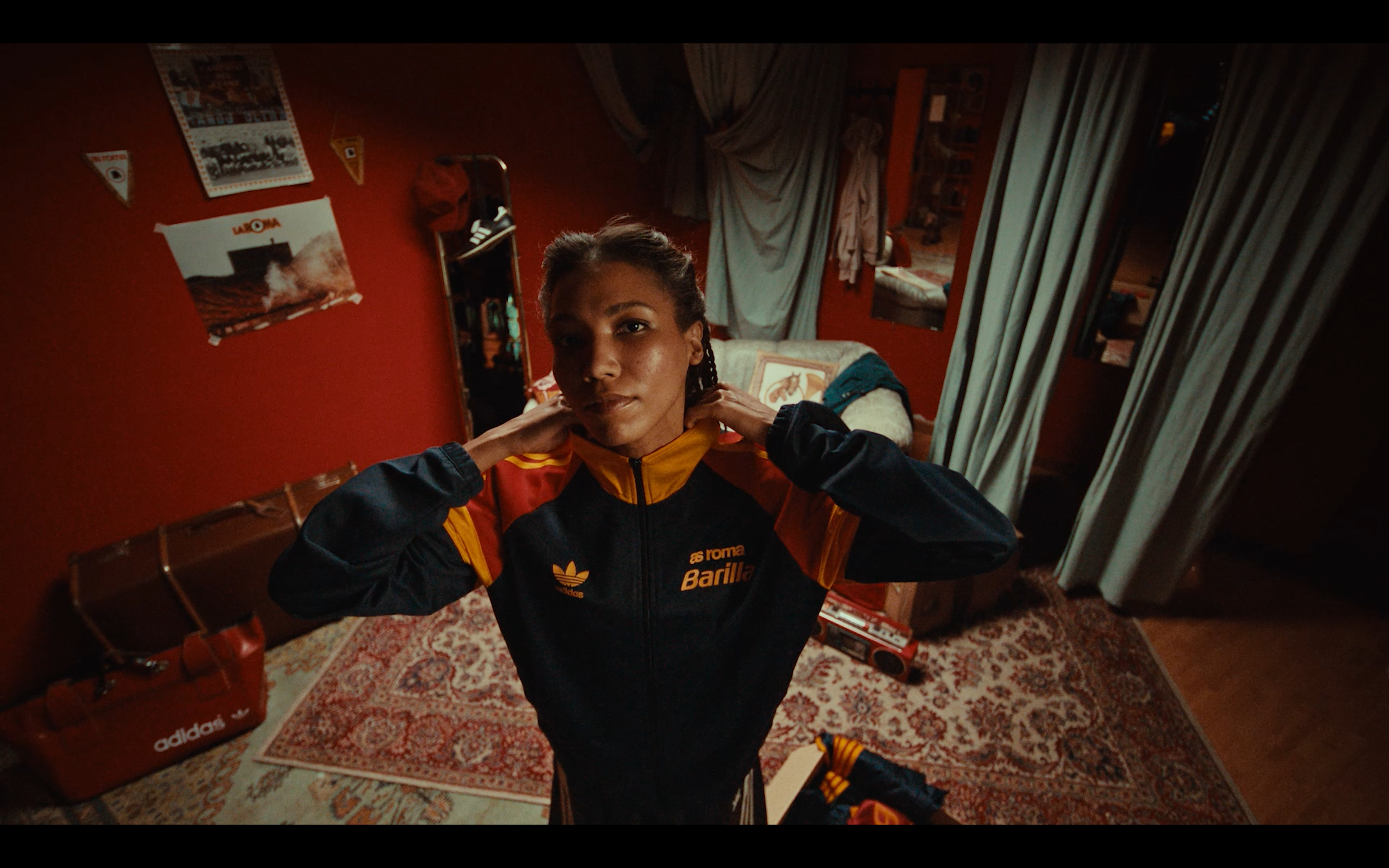 An overhead portrait in an Adidas × AS Roma tracksuit
