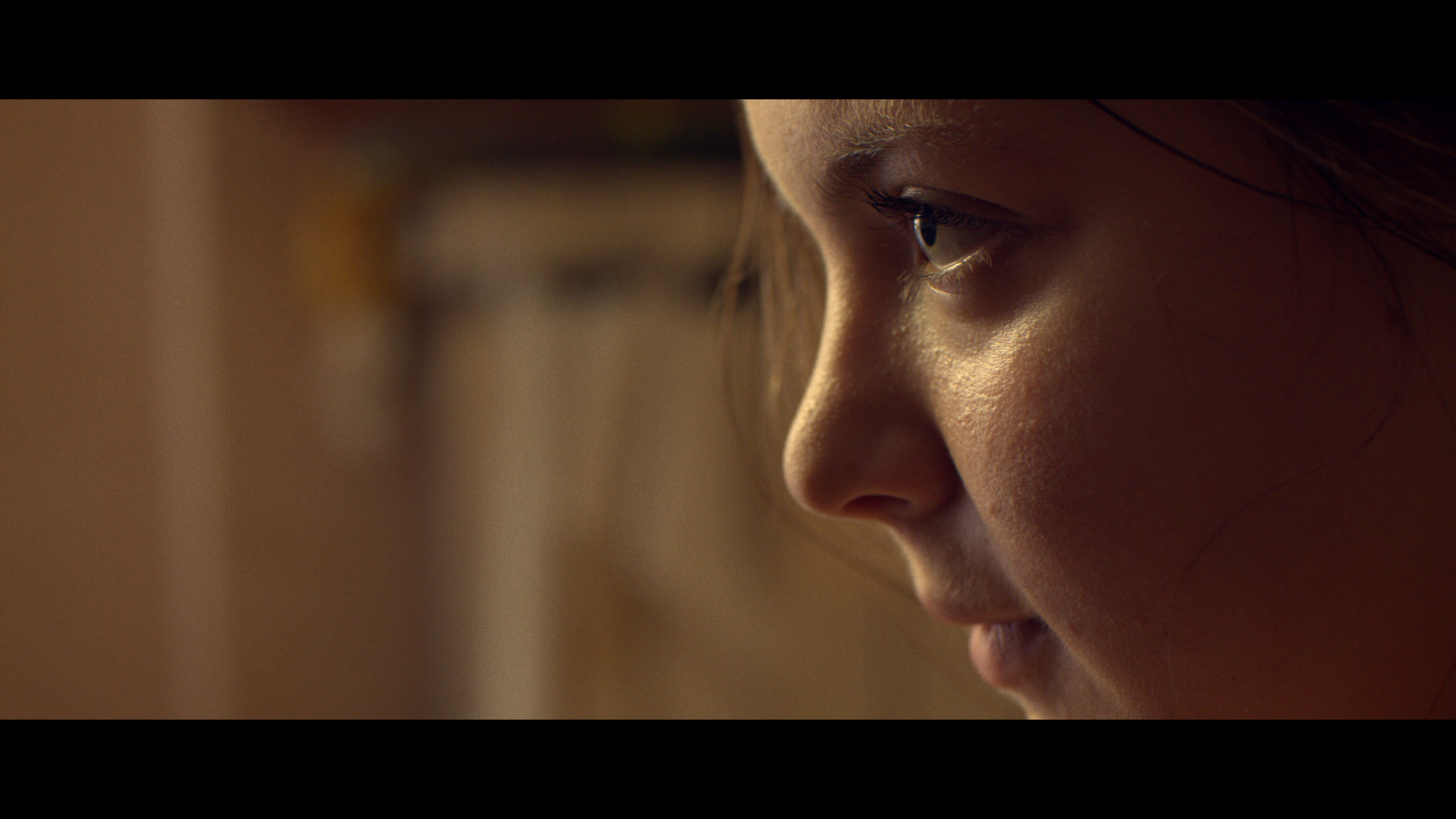 A woman in profile in warm light