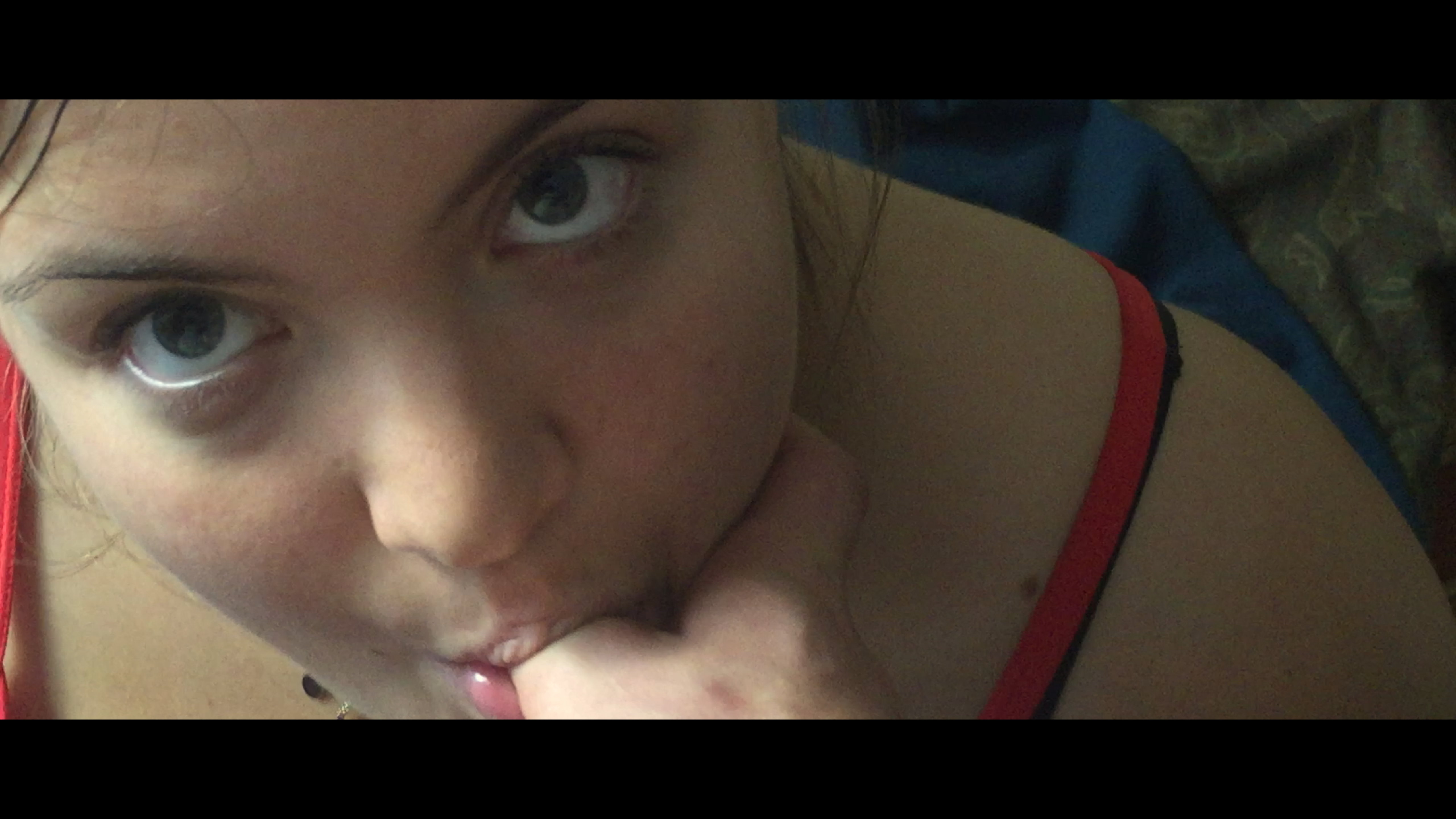 An overhead close-up of a woman looking at the camera
