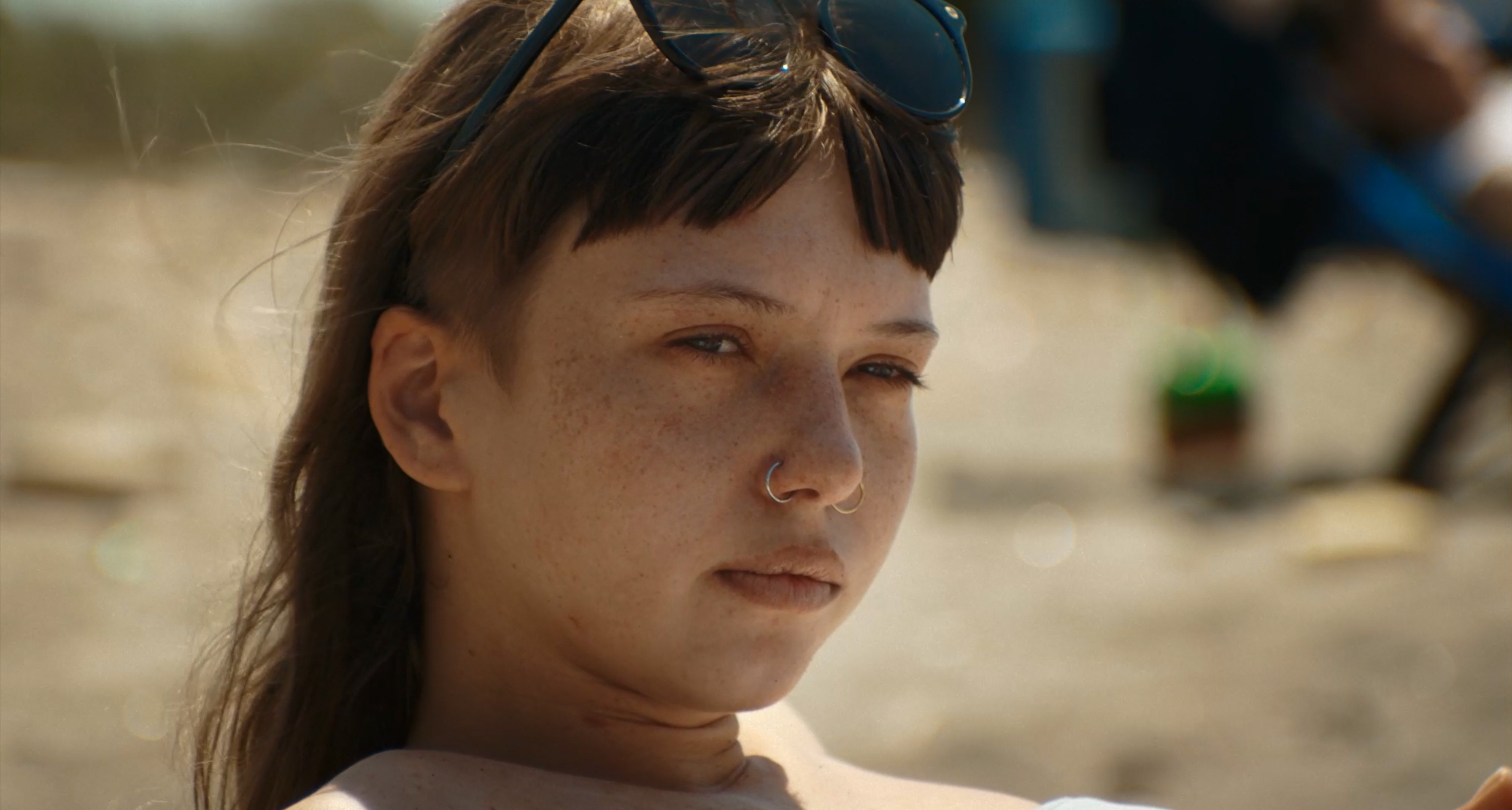A close-up portrait of a woman on the beach