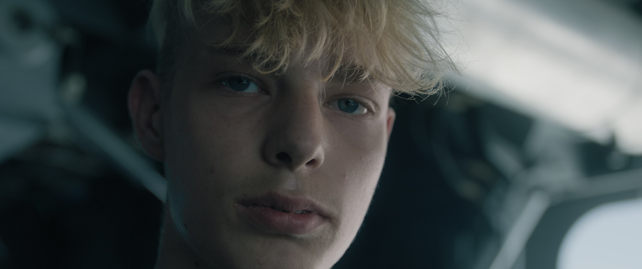 A close-up of a young man aboard a ship
