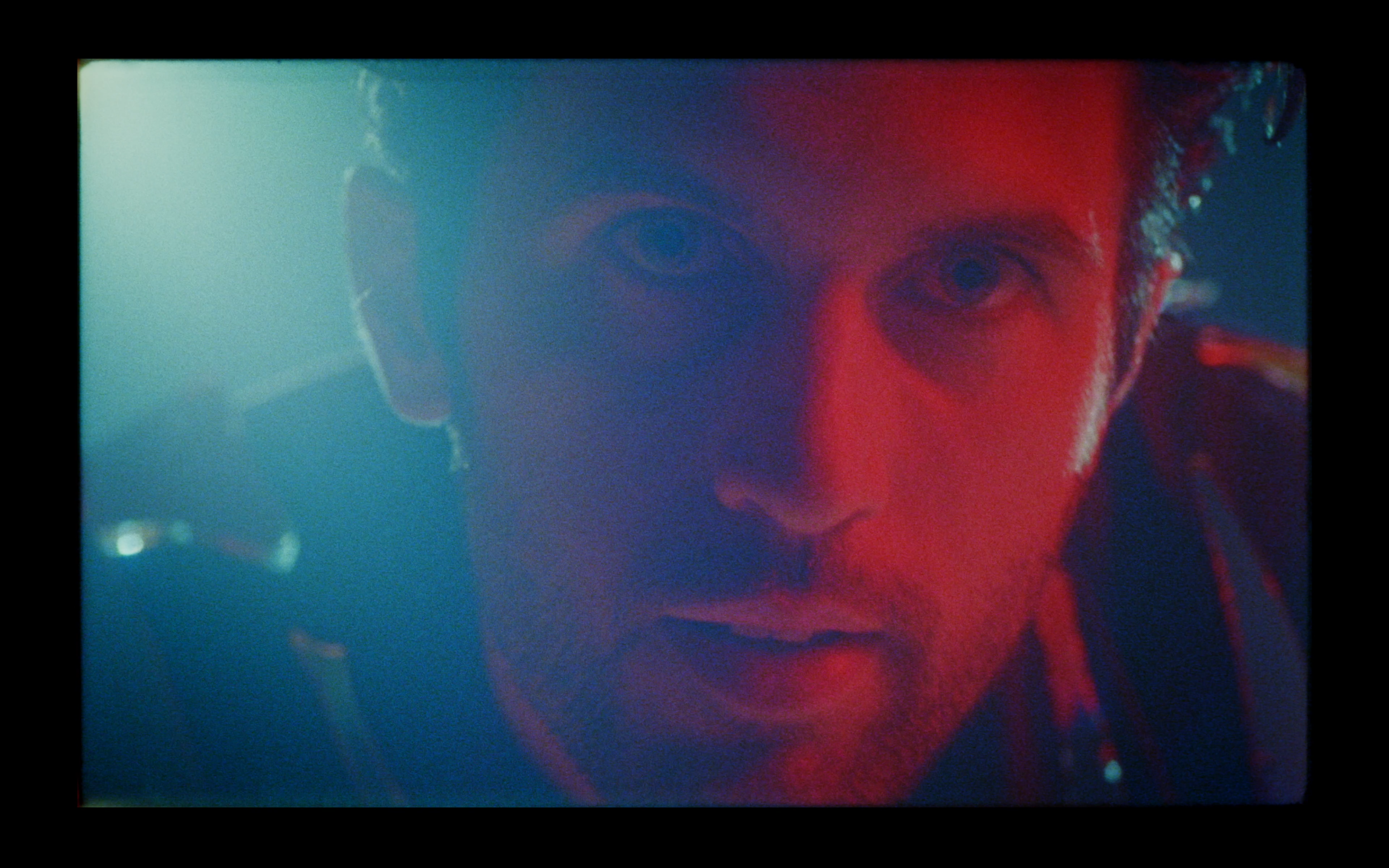 A close-up in cyan and red light