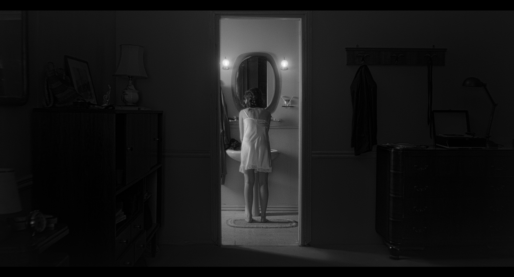 A woman at the bathroom mirror