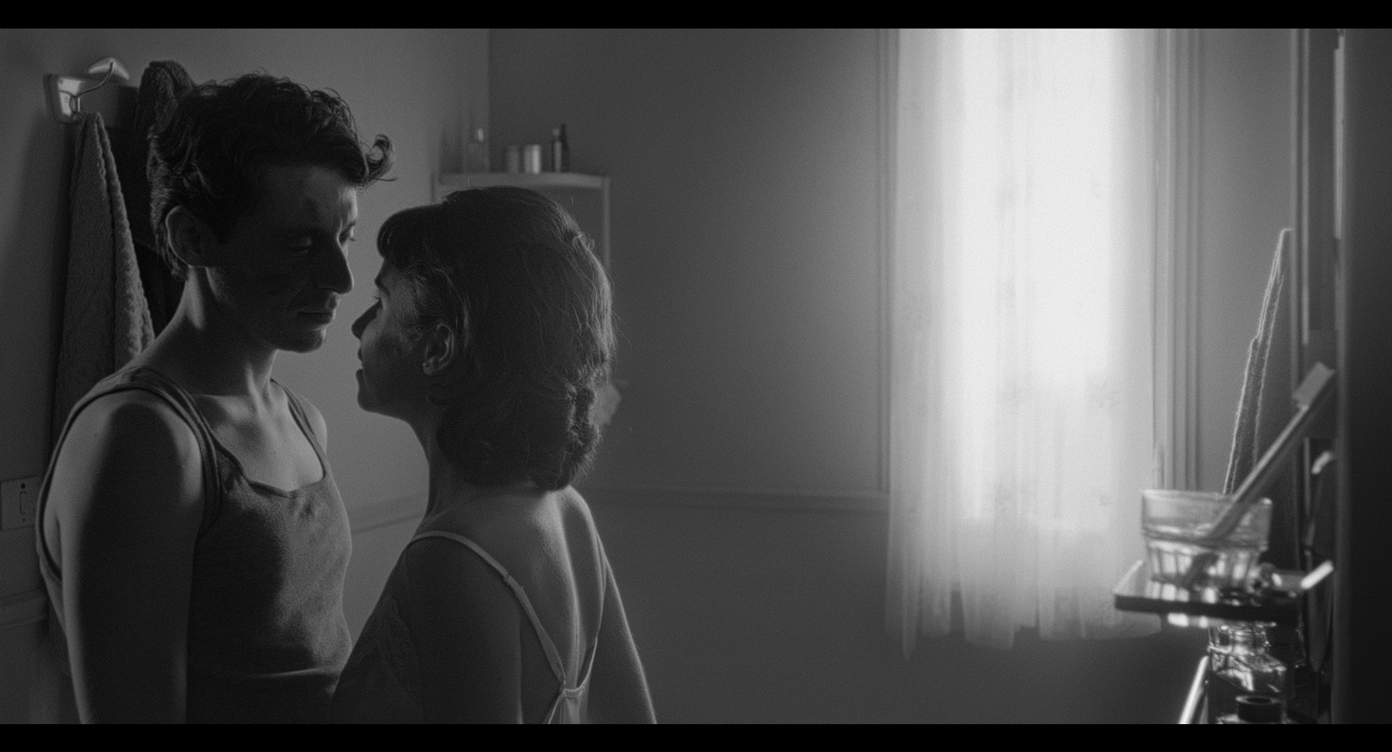 A couple standing beside a bright window