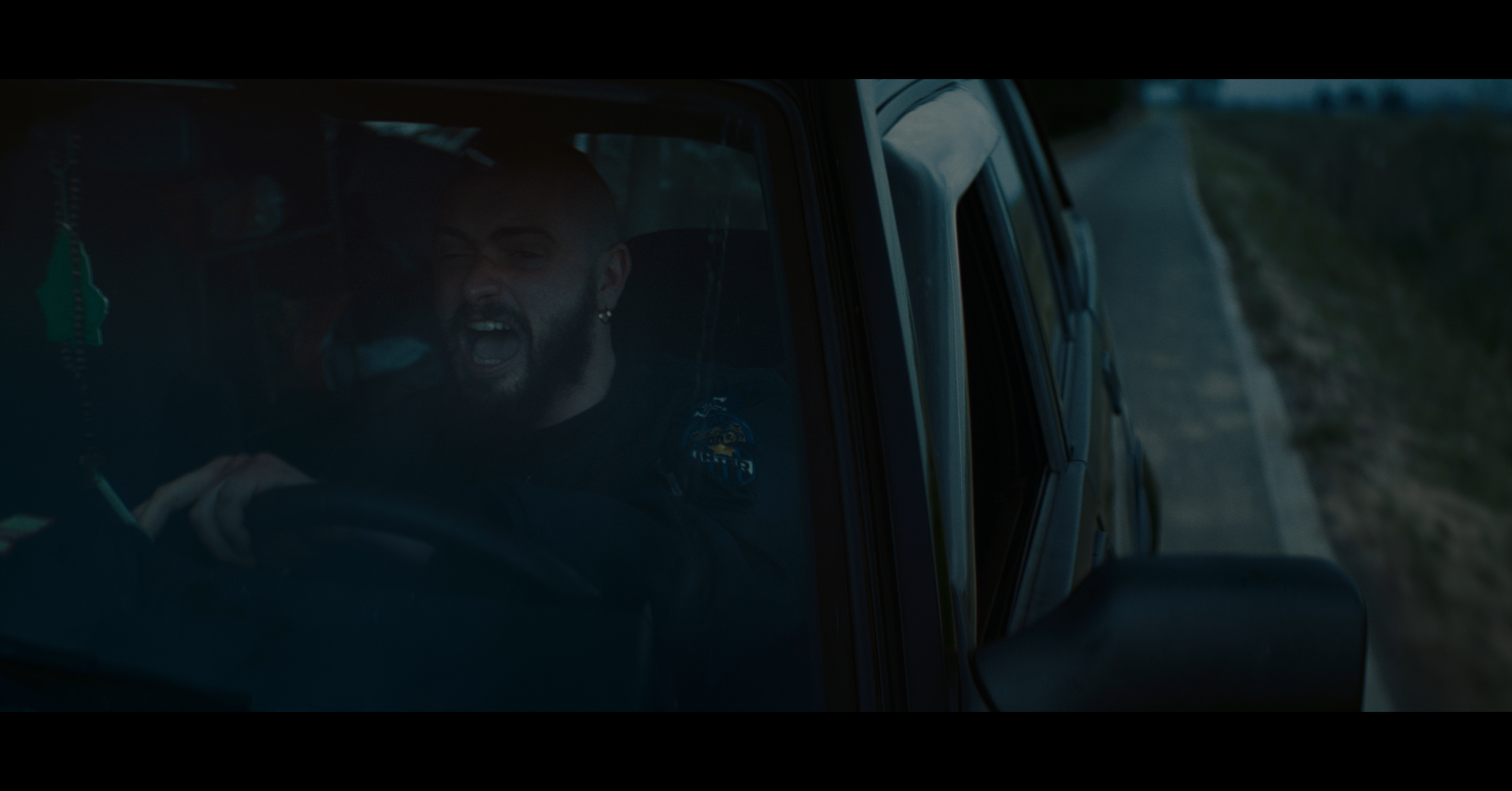 A man seen through the window of a van