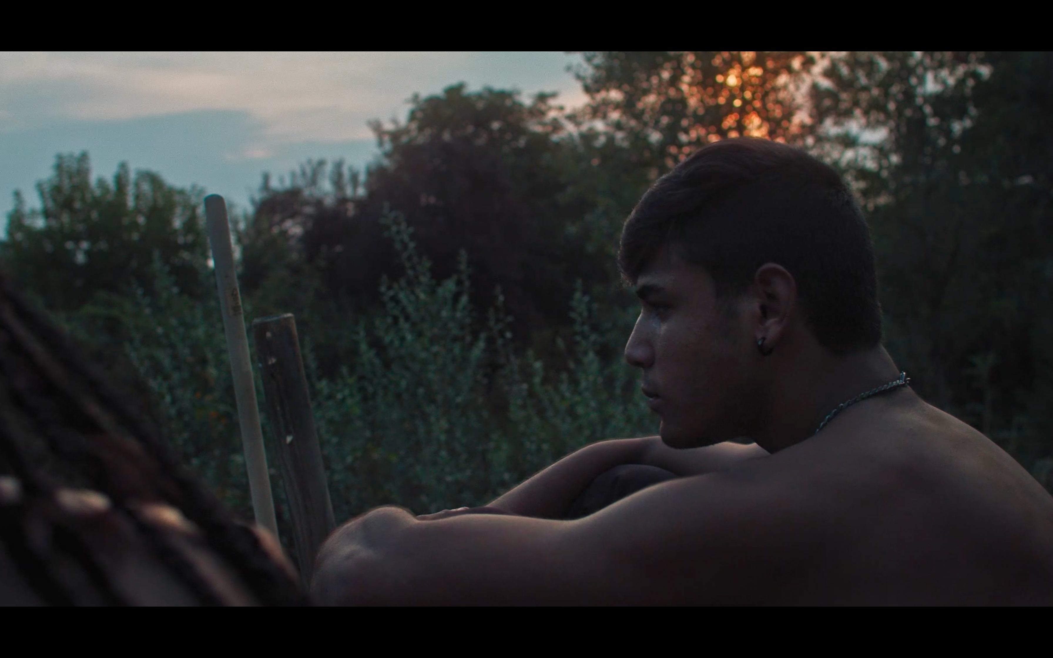 A portrait of a man outdoors at sunset