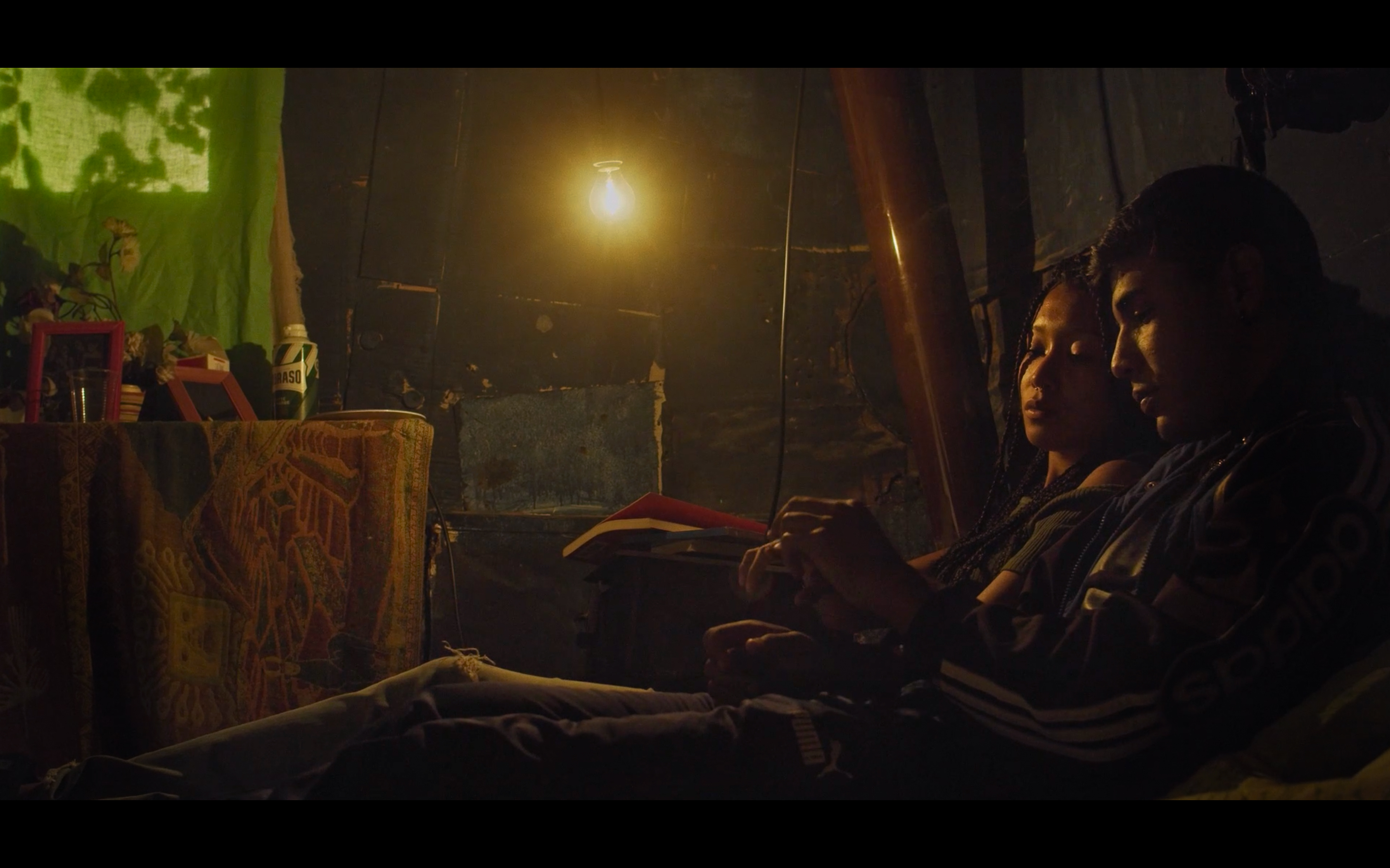 Two people resting together beside a warm lamp