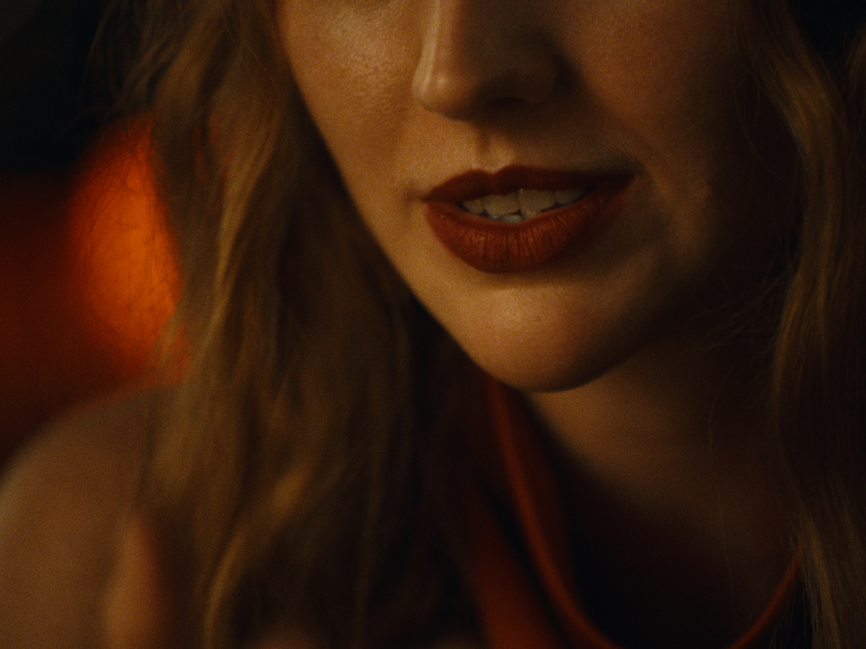 A close-up of a woman in warm orange light