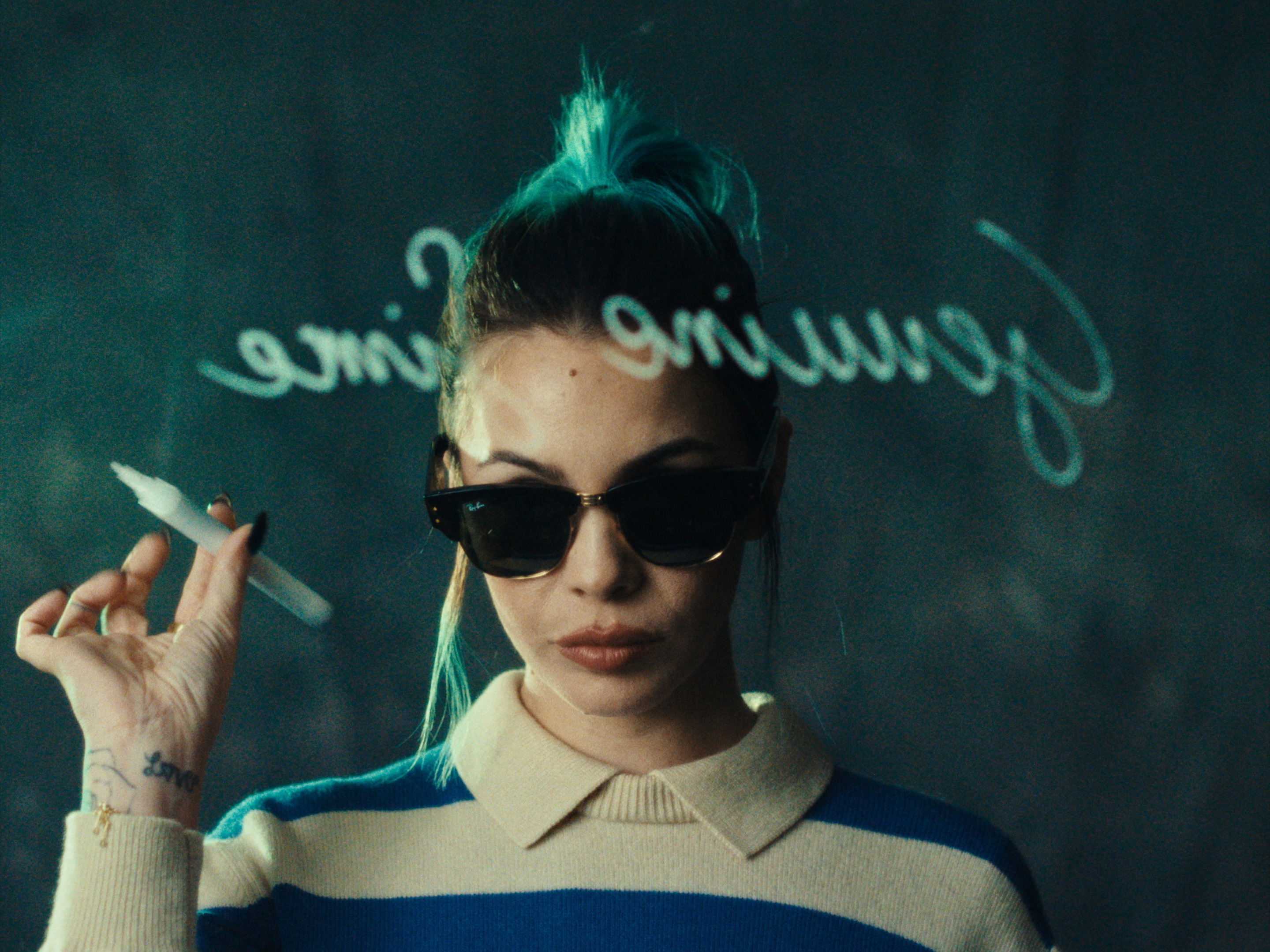 A woman wearing sunglasses with projected handwriting