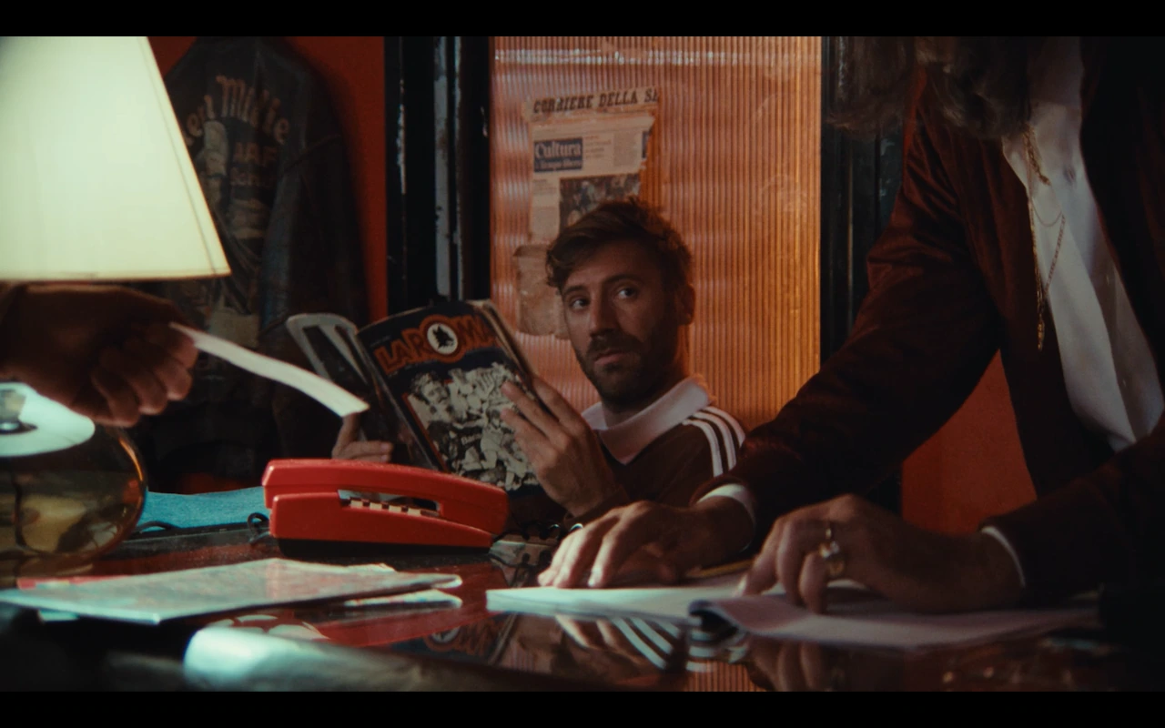 A scene at the counter with a red telephone and an AS Roma magazine