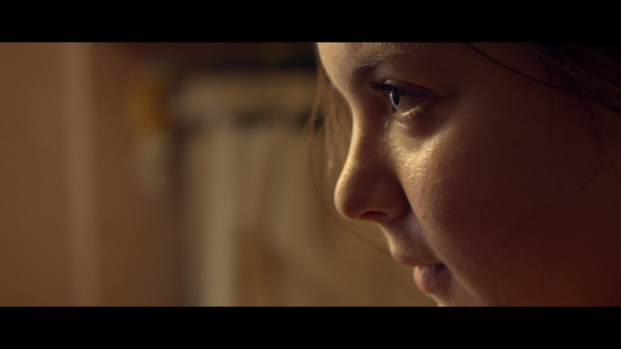 A woman in profile in warm light
