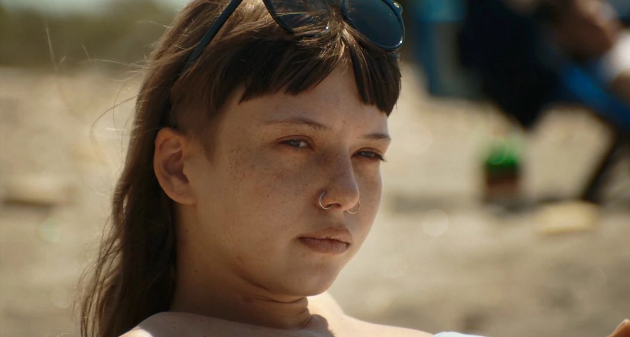 A close-up portrait of a woman on the beach