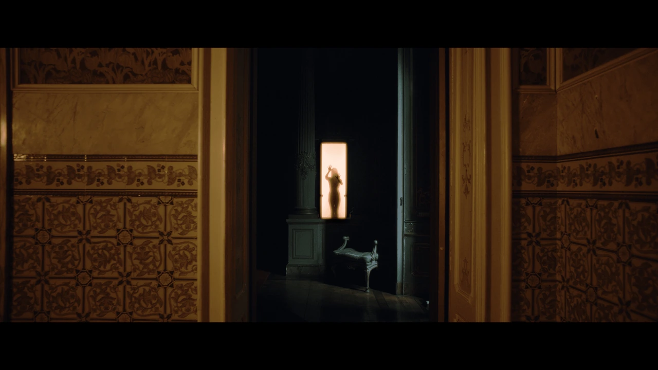 A backlit silhouette framed by a bright doorway