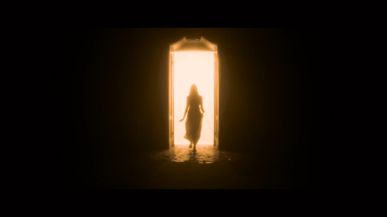 A silhouette emerging through a bright doorway