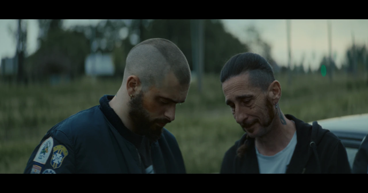 Two men talking outside in soft evening light