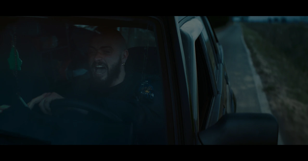 A man seen through the window of a van
