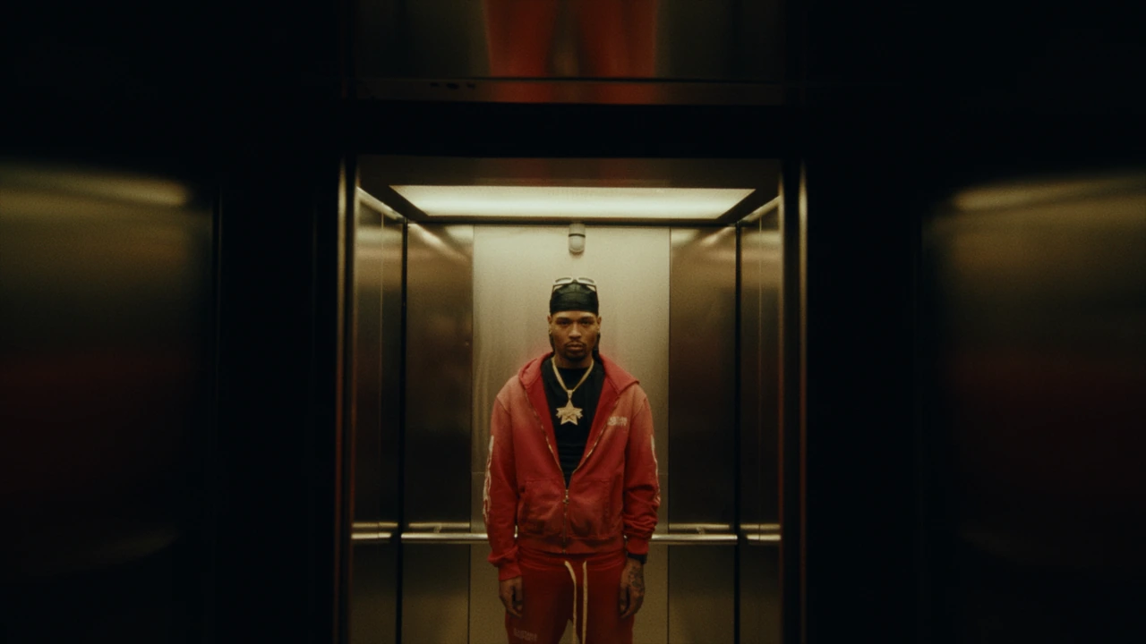 An artist standing in a warmly lit elevator
