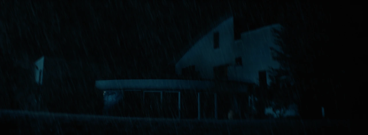 A house at night through heavy rain