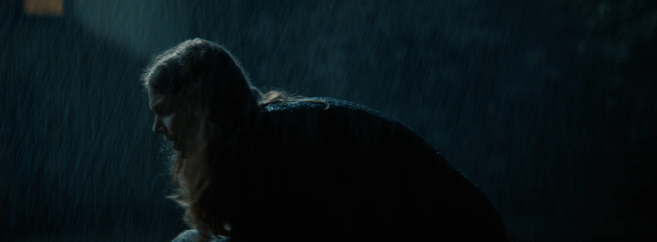 A woman in profile under the rain