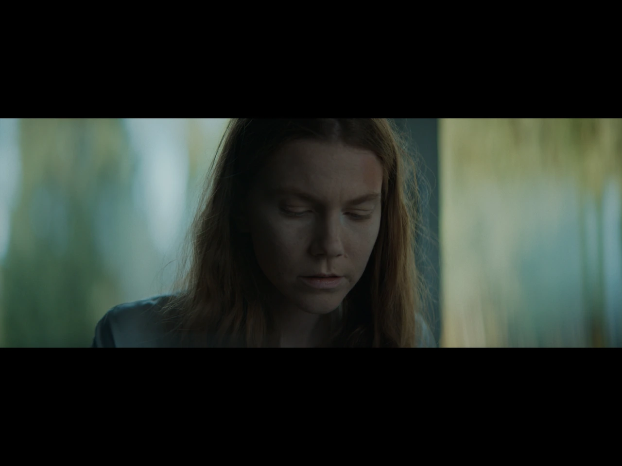 A woman looking down in daylight