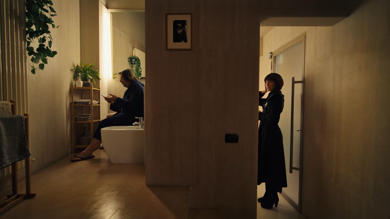 Two people speaking across an interior doorway