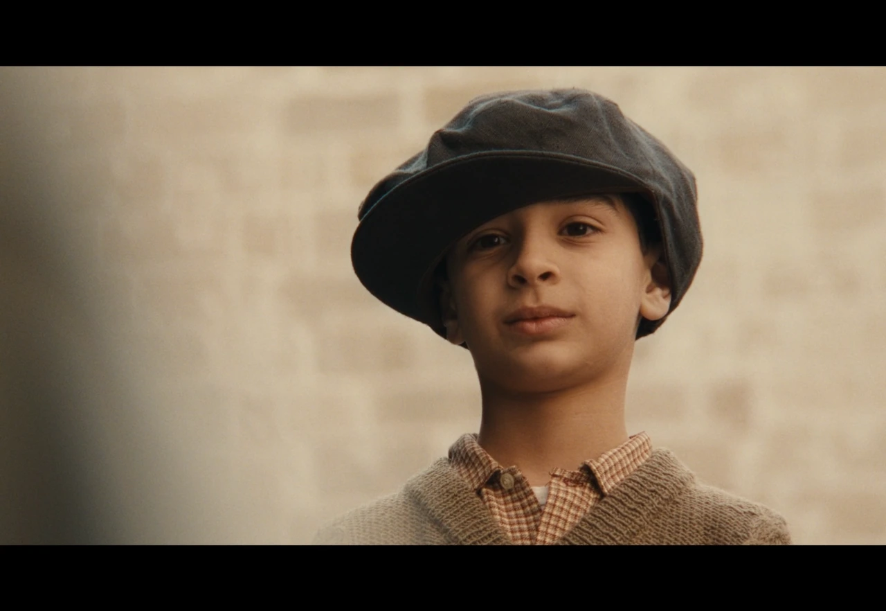 A boy wearing a cap in warm daylight
