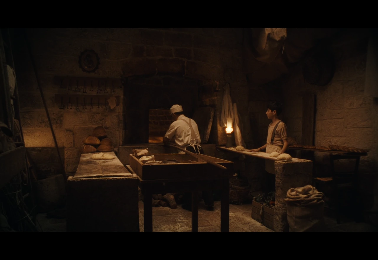 A baker and a boy inside a stone bakery