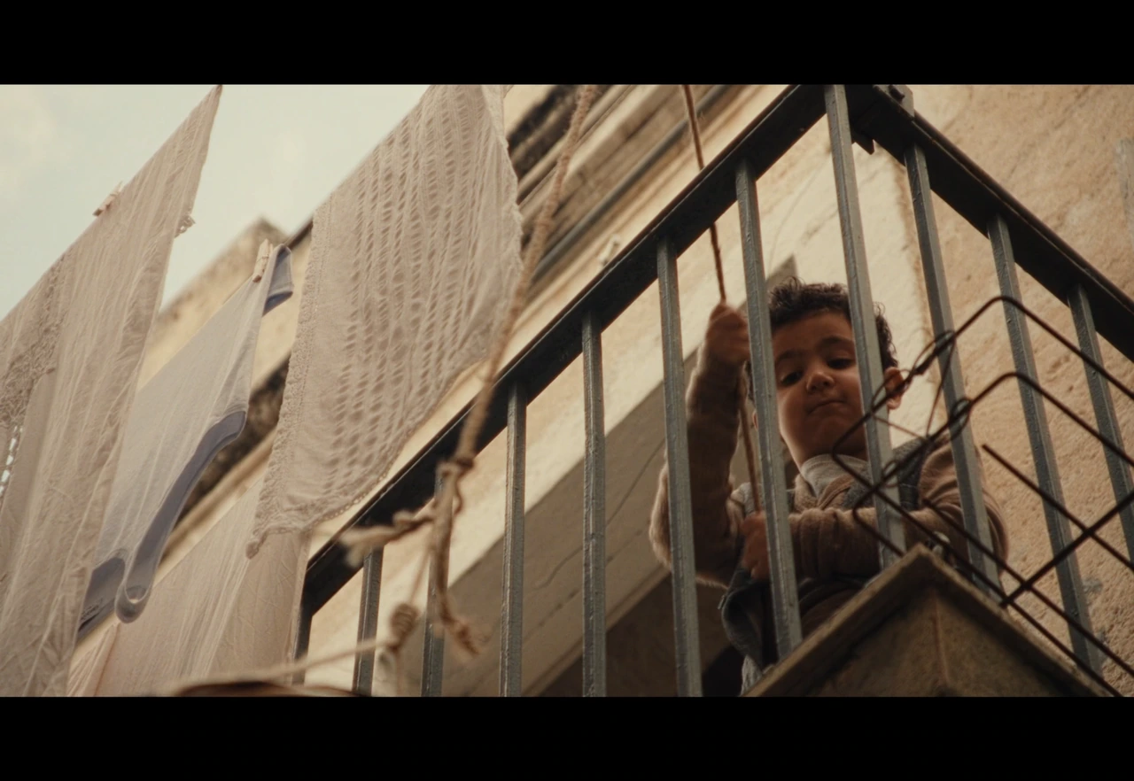 A child beside hanging laundry