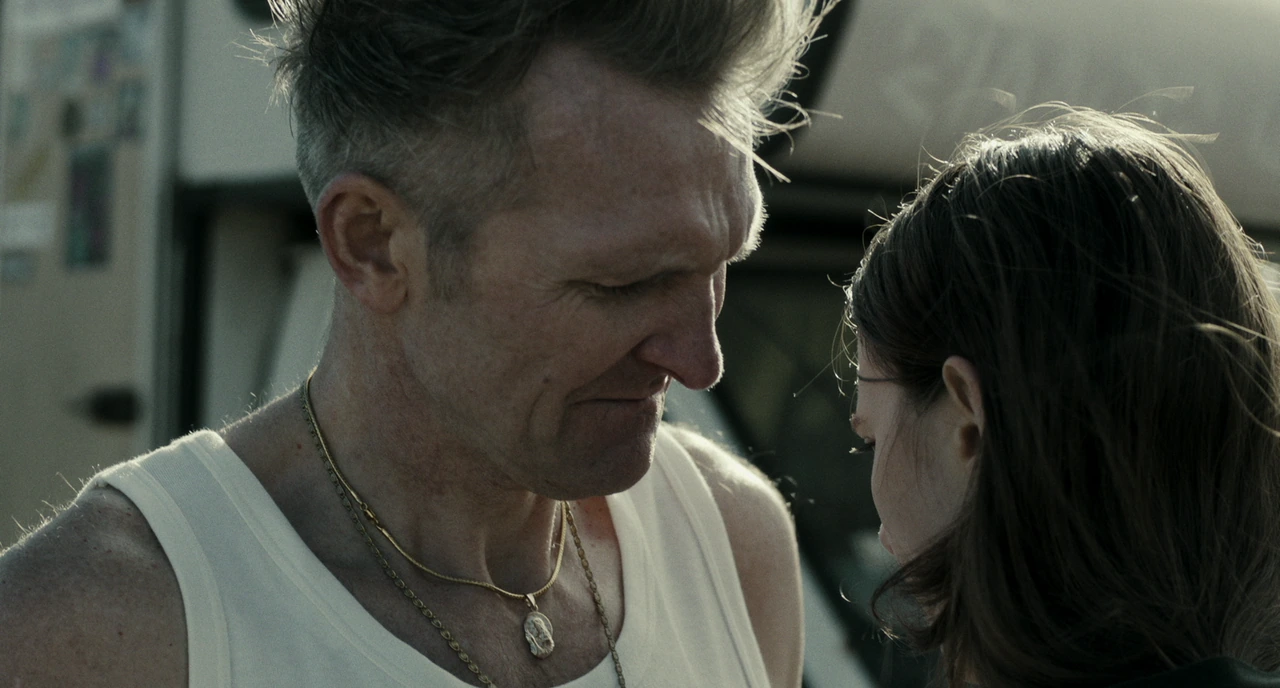 A man and woman talking on the beach