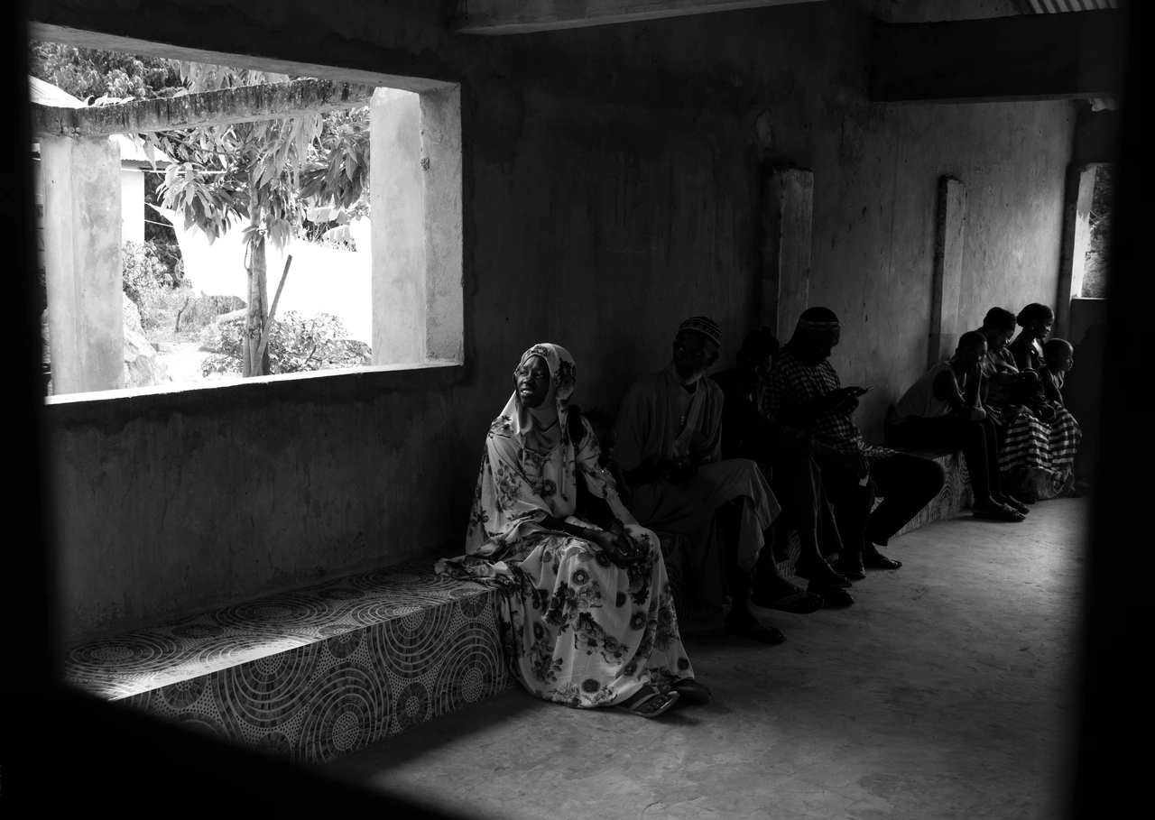Women seated beside an open window in black and white