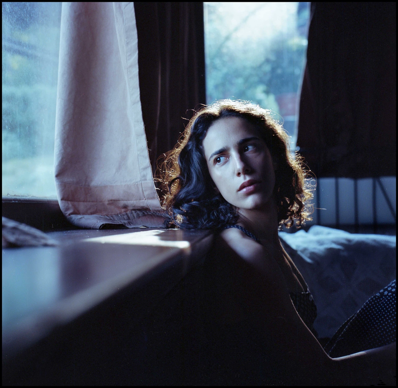 A portrait beside a window in cool daylight