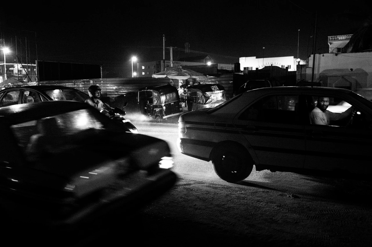 Night traffic and a driver in black and white